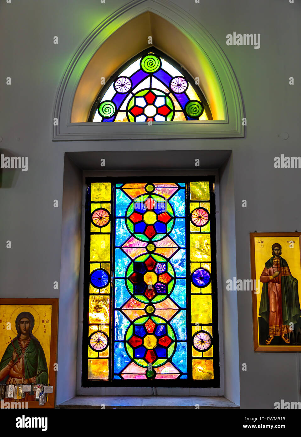 Old stain glass window in an alcove of the Church of Saint Titus. Stock Photo