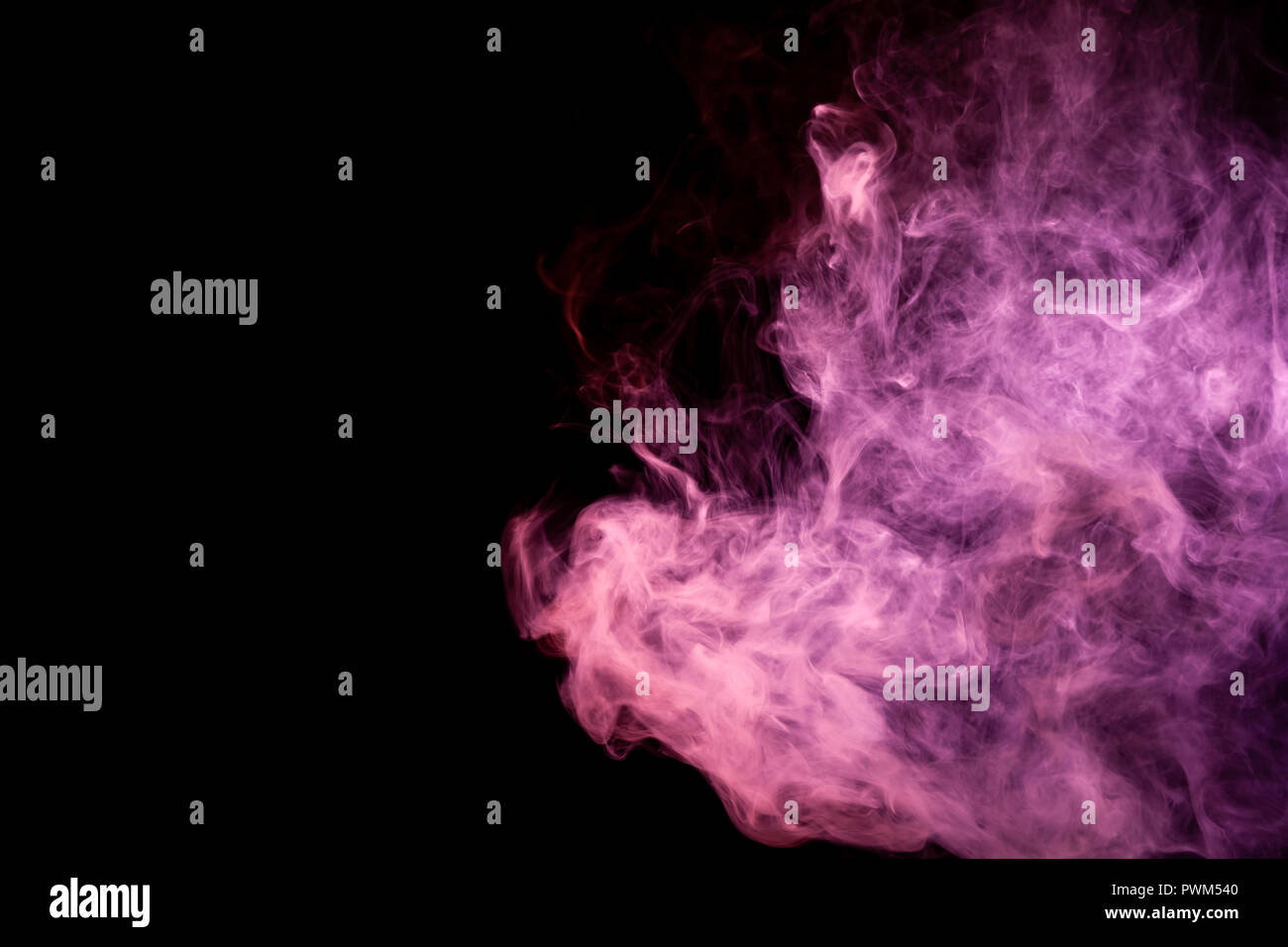 Textural background for creativity . Dense multicolored smoke of   red and pink colors on a black isolated background. Background of smoke vape Stock Photo
