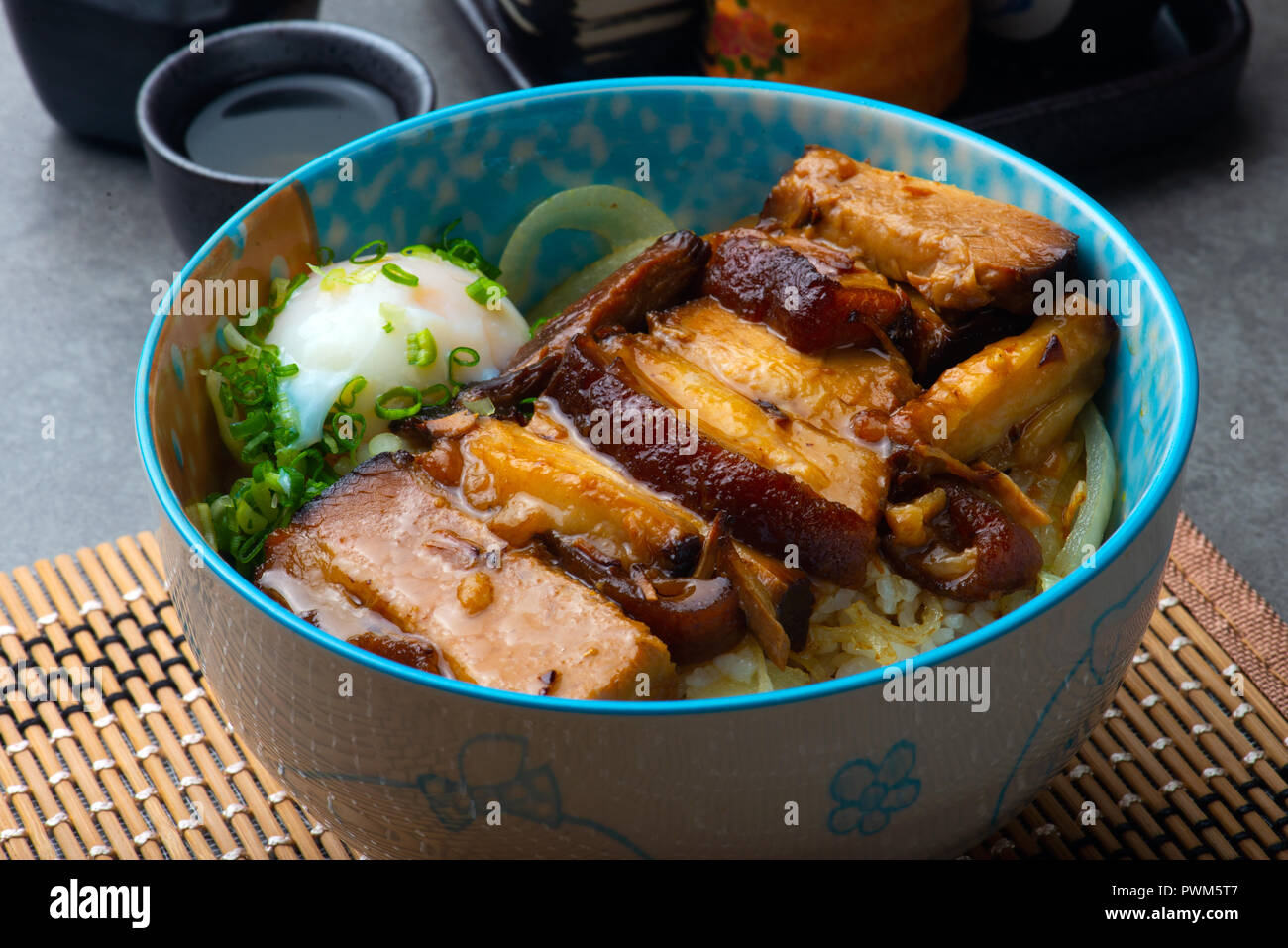 bowl of rice topped with Braised pork belly don Stock Photo Alamy