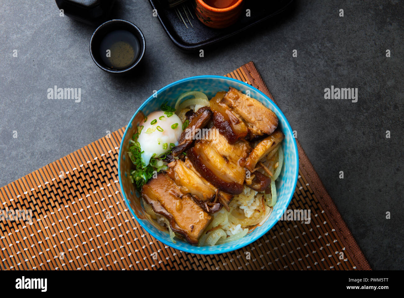 bowl of rice topped with Braised pork belly don Stock Photo Alamy