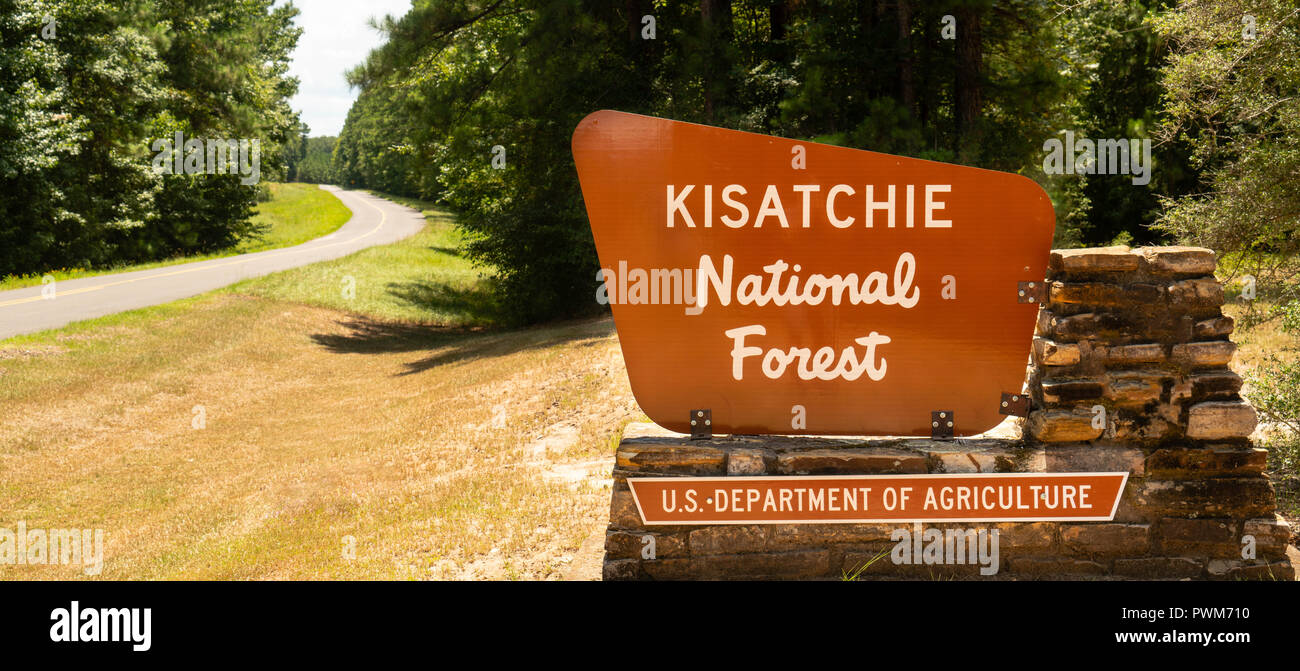 Two lane road passes entrance sign to Kisatchie National Forest Stock Photo