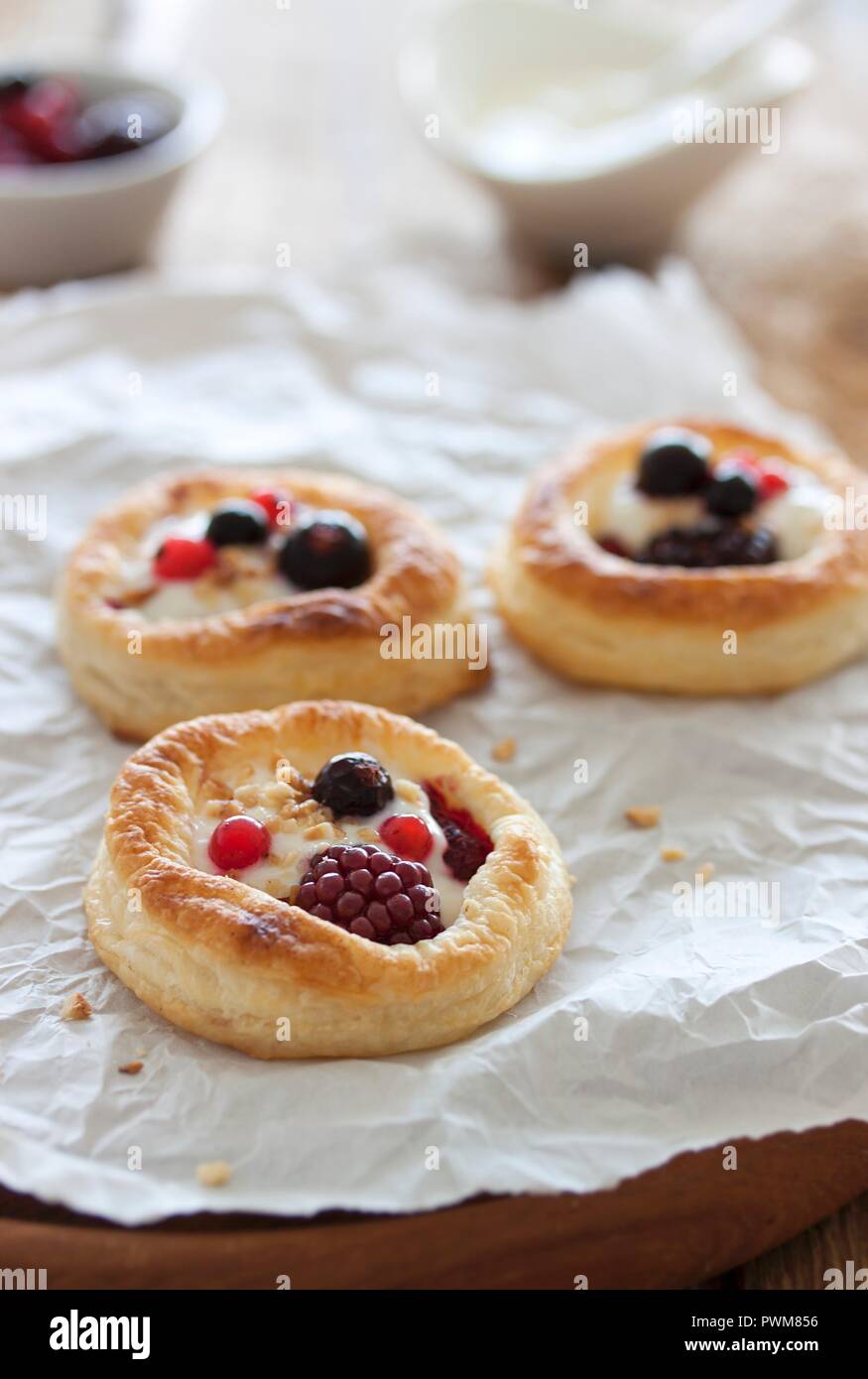 Puff pastry tartlets with a berries and a vanilla and quark filling Stock Photo