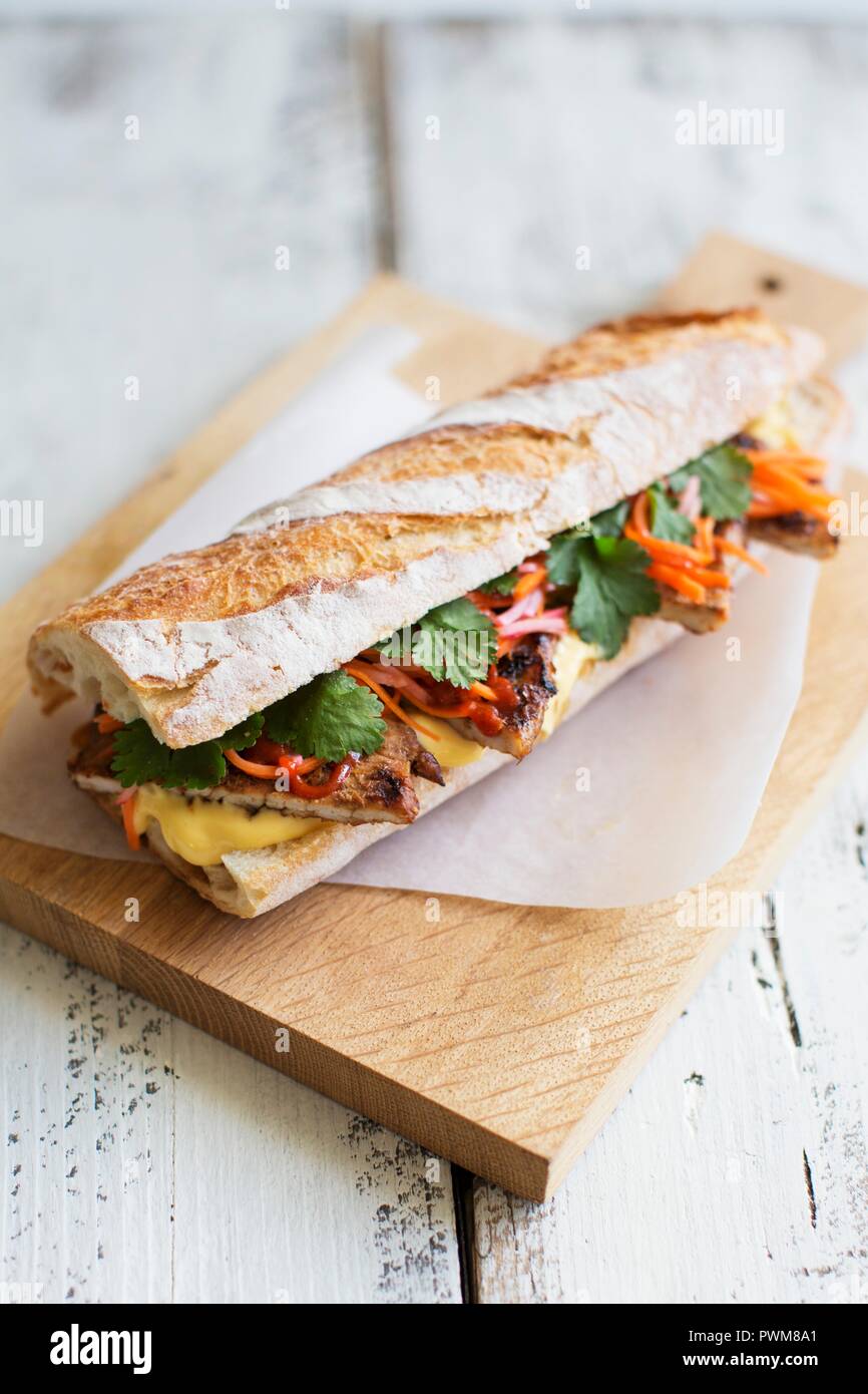 Banh Mi sandwich with pork, coriander, pickled carrots radishes and