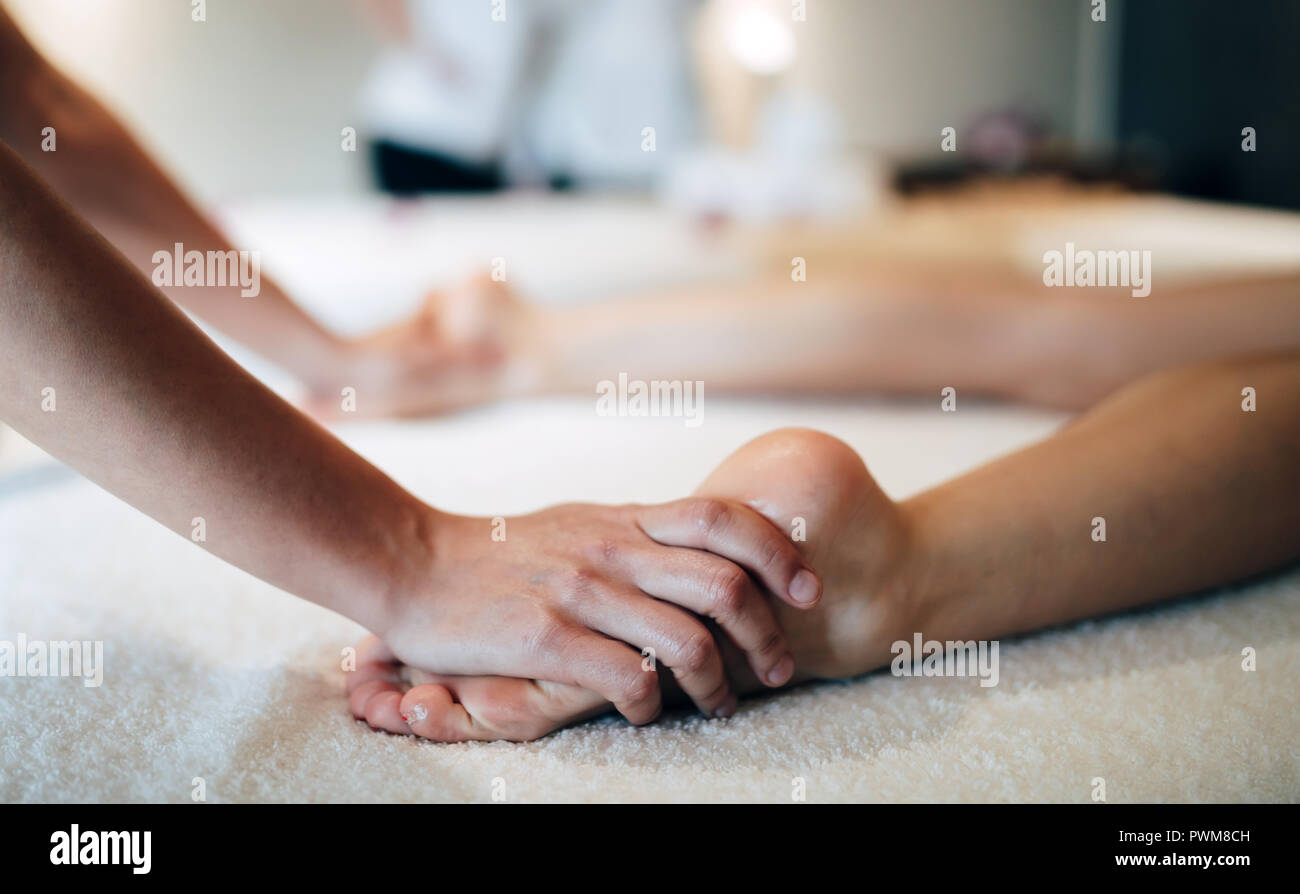 Foot and sole massage in therapeutic relax treatment Stock Photo