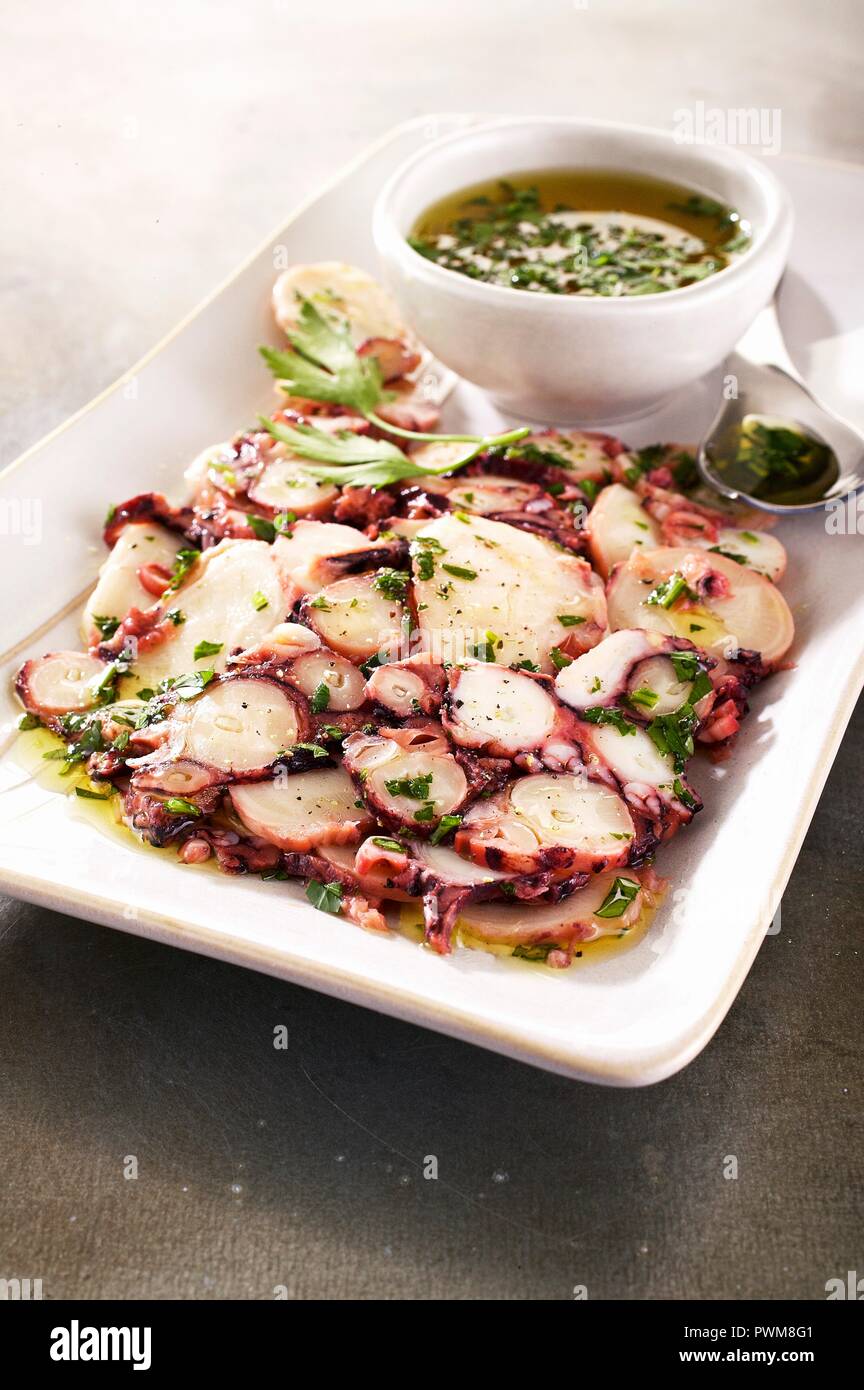 Carpaccio of octopus with herb oil Stock Photo