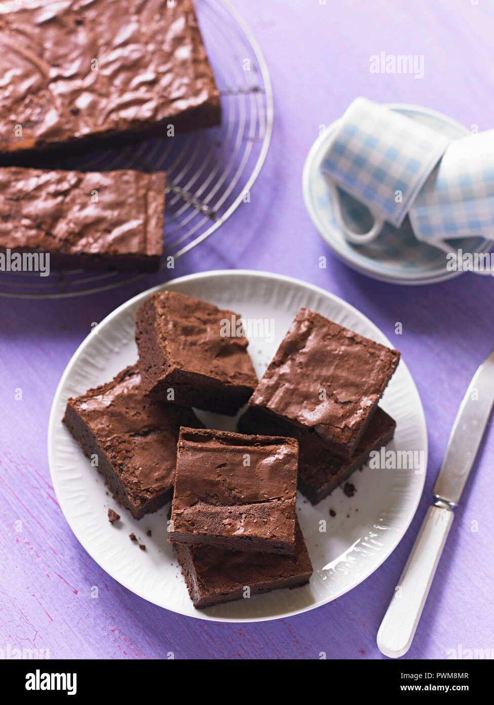 Brownies on a wire rack and on a plate Stock Photo