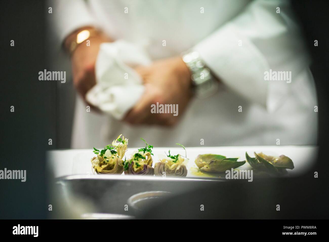 Marinated artichokes in a restaurant kitchen Stock Photo Alamy