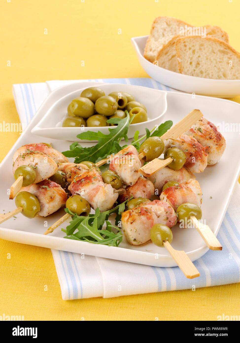 Chicken and bacon kebabs with green olives Stock Photo Alamy