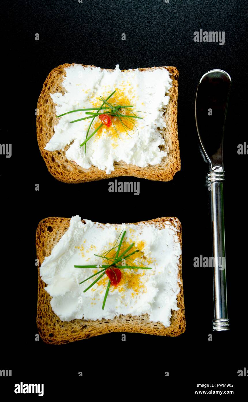 Melba toast with goat's cheese and bottarga Stock Photo