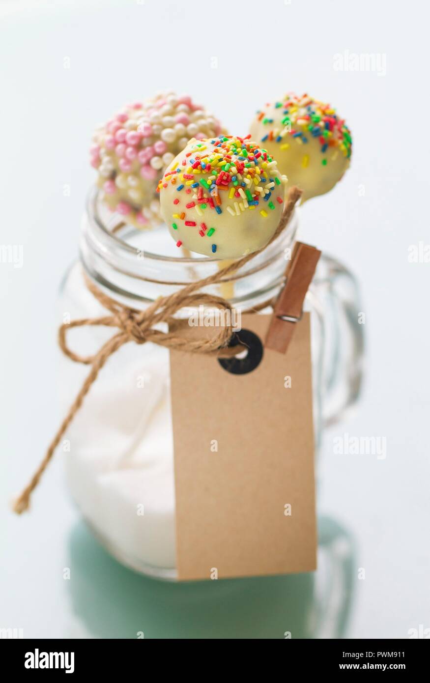Cake pops with a white chocolate glaze and sugar beads Stock Photo