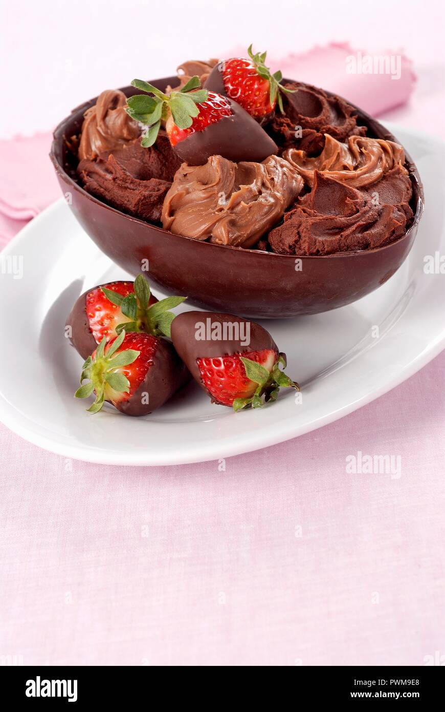 A chocolate egg filled with chocolate cream and chocolateglazed strawberries Stock Photo Alamy