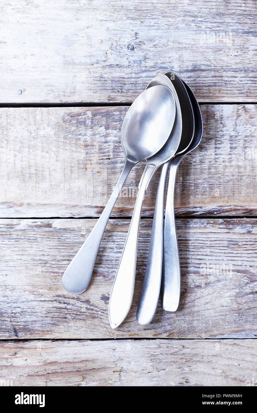 Several soup spoons on a wooden background Stock Photo