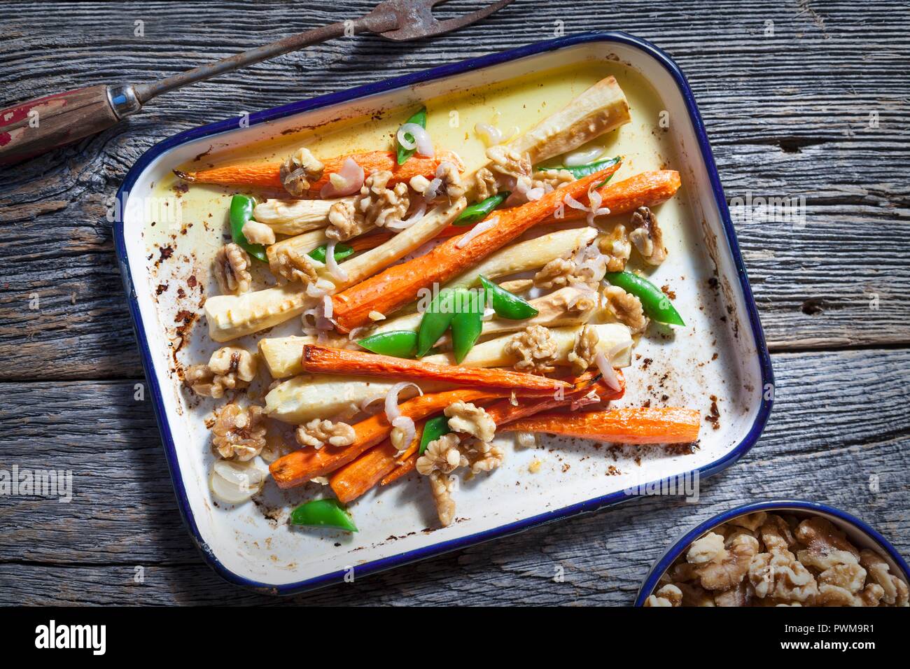 Ovenroasted carrots and parsnips with walnuts Stock Photo Alamy
