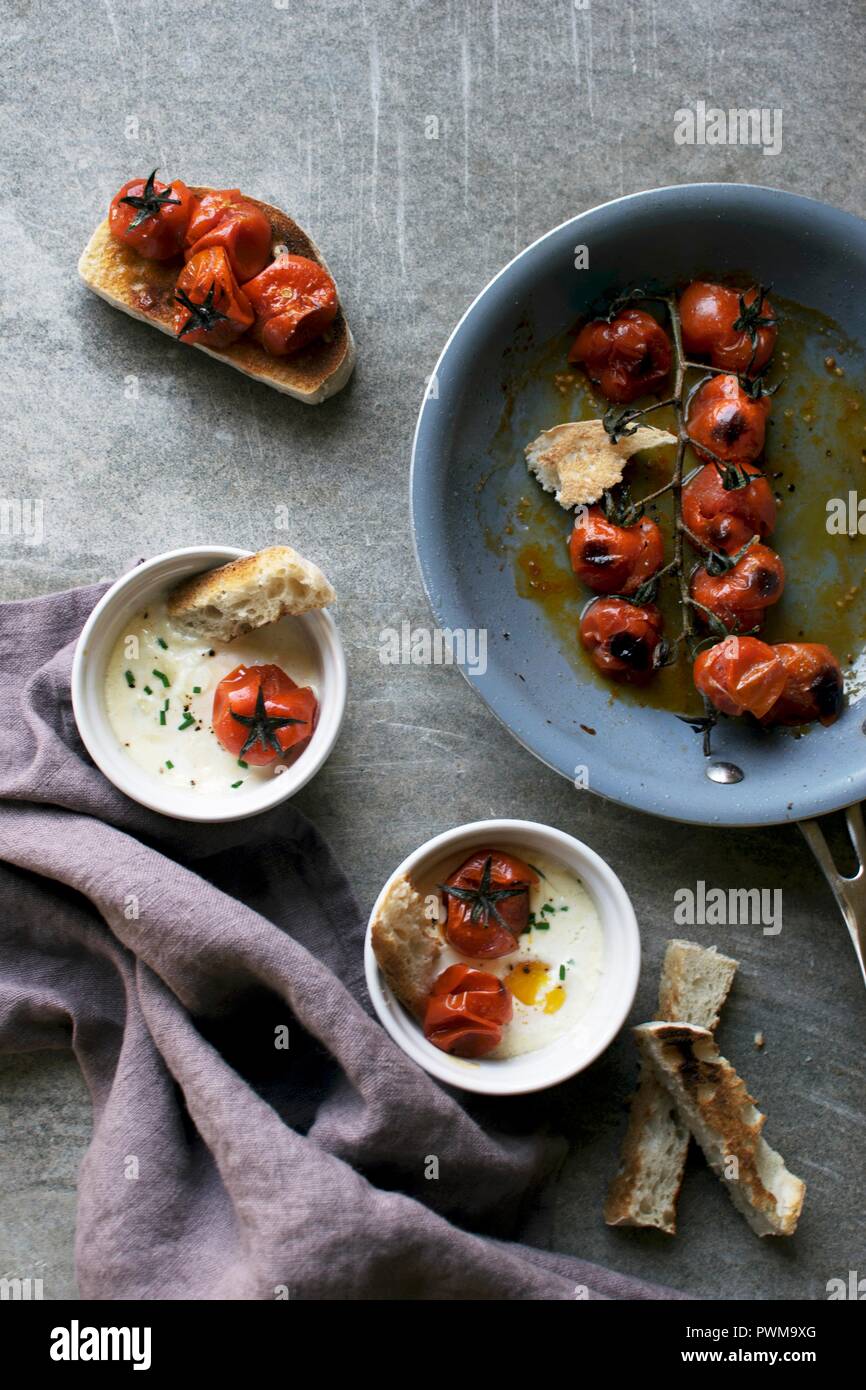 Egg cocotte with fried cherry tomatoes Stock Photo Alamy