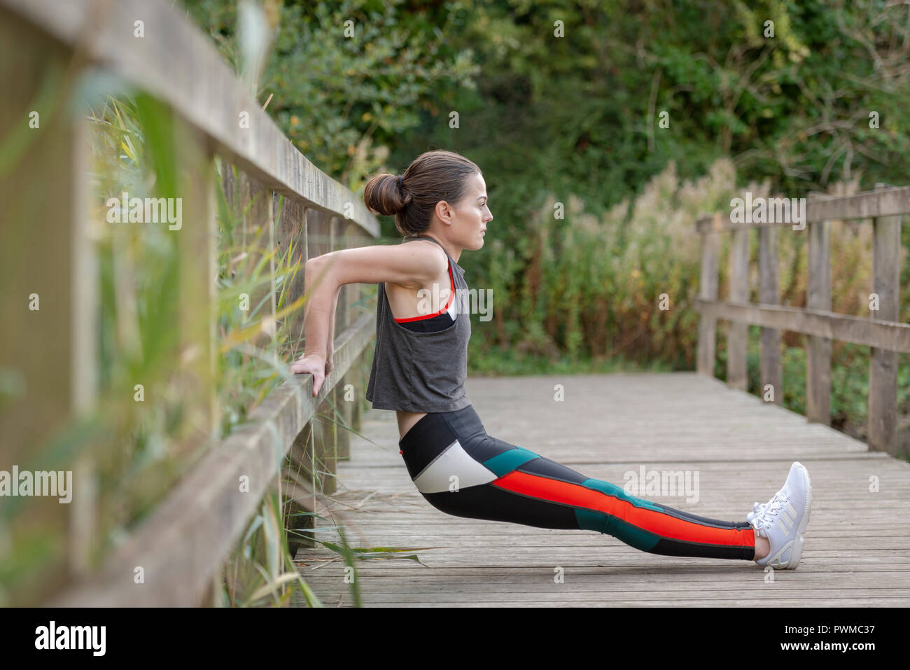 sporty woman stretching and exercising outside Stock Photo