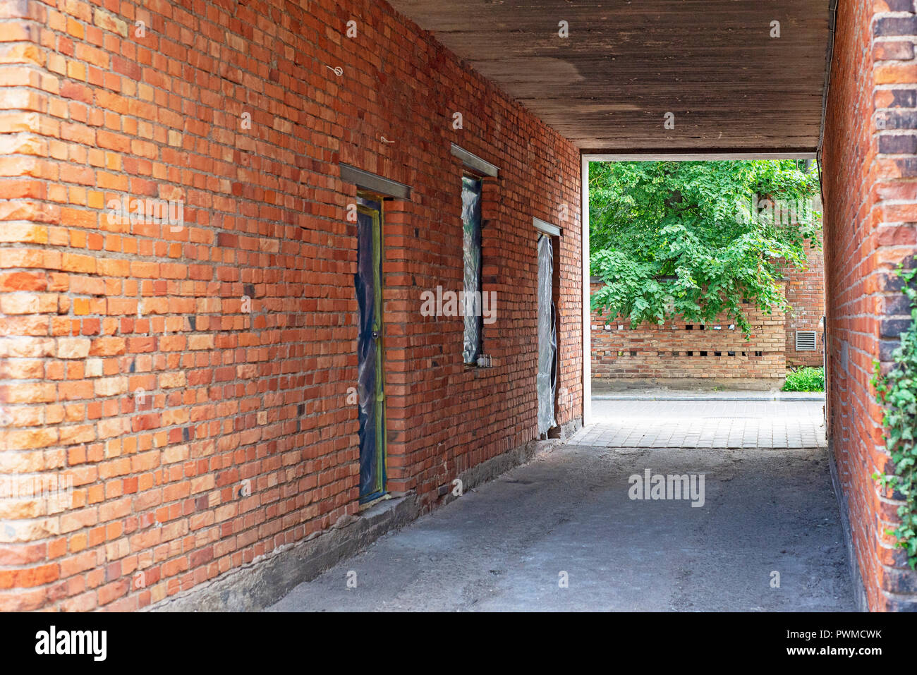 Narrow red brick wall alley in old town Stock Photo Alamy