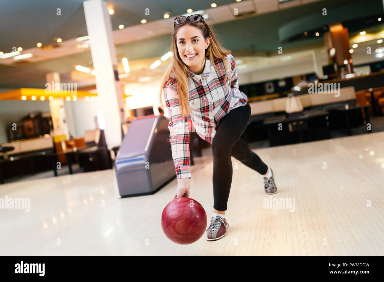 Woman throwing bowling ball Stock Photo Alamy