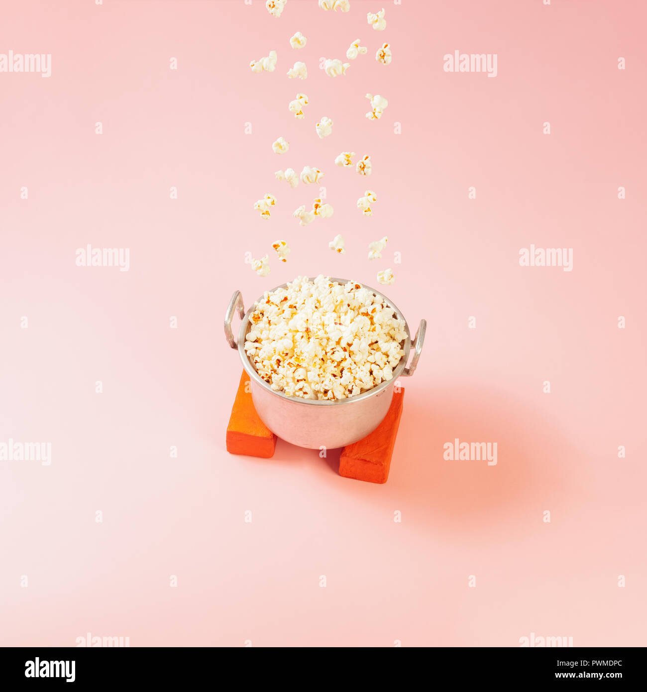 Popcorn raining upside down form a tin pot full of popcorn Stock Photo