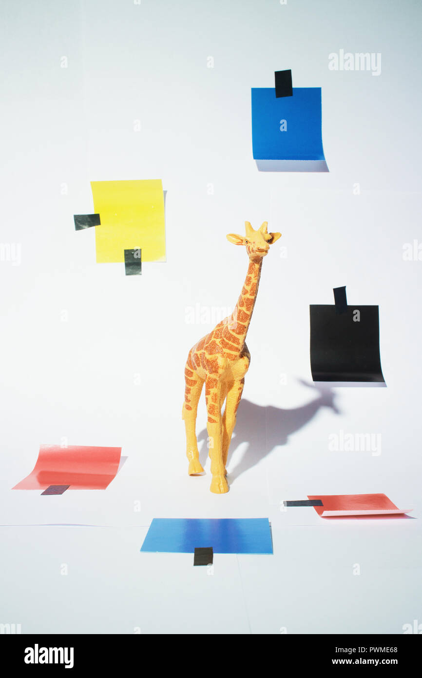 Giraffe toy studio shoot with a piet mondrian inspired decorations Stock Photo