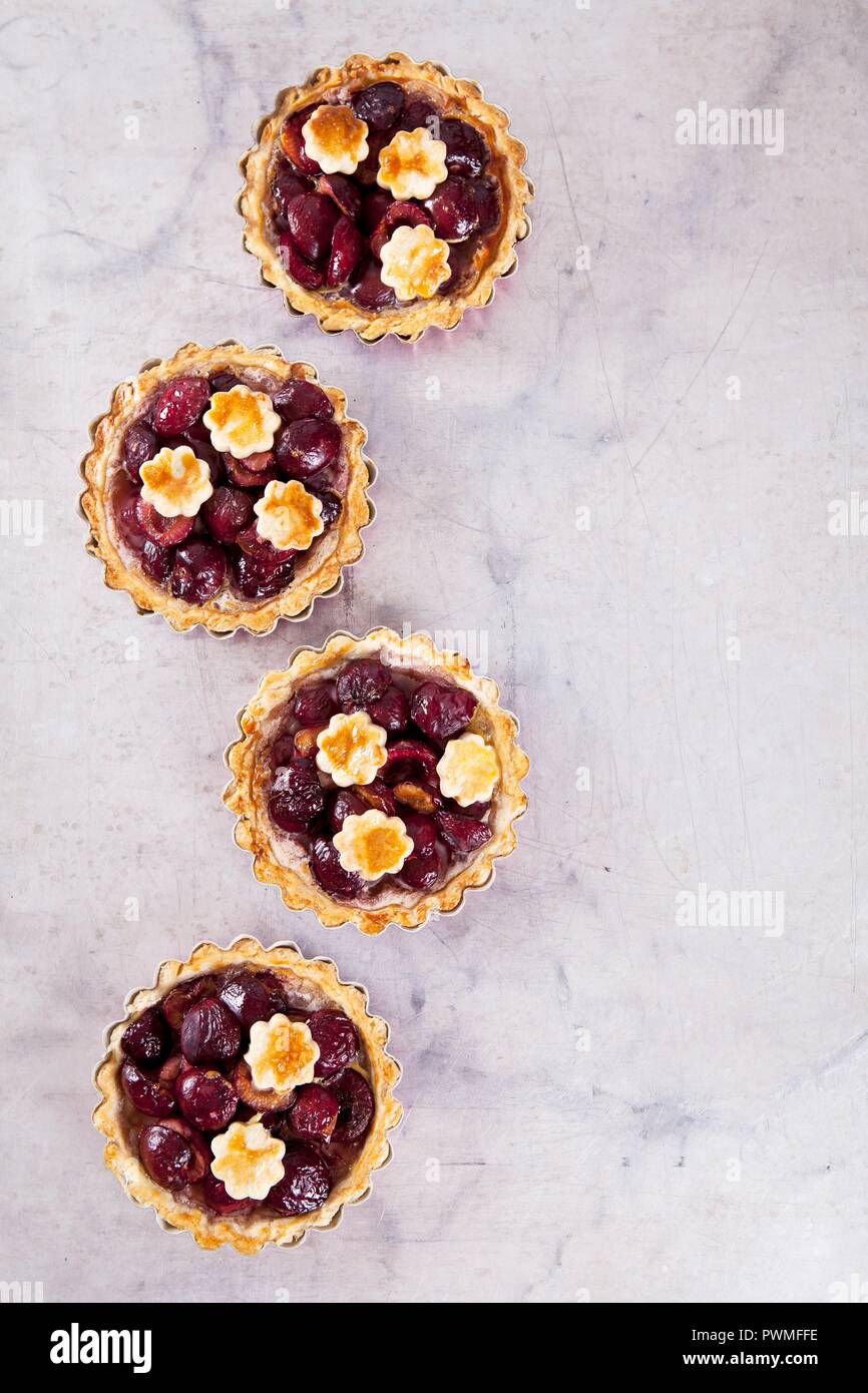 Mini shortcrust pies with cherries (seen from above Stock Photo Alamy