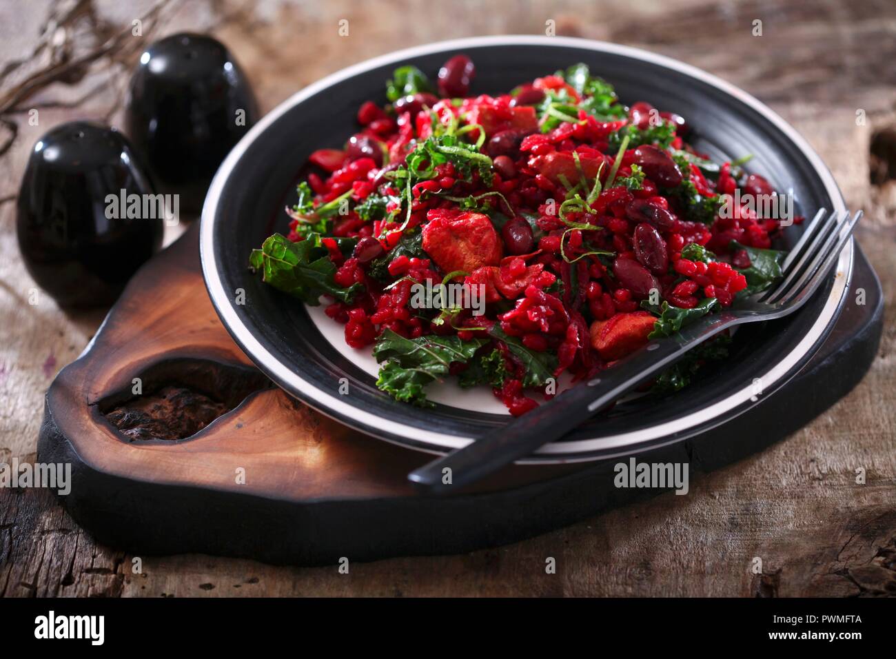 Red risotto with kidney beans and kale Stock Photo Alamy