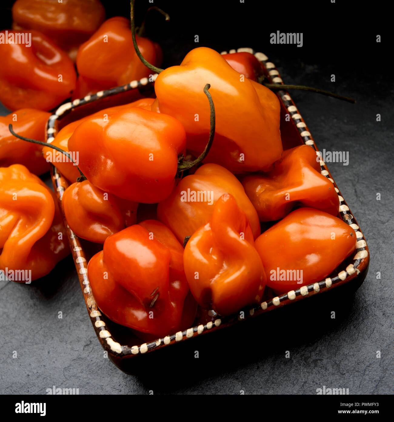 Fresh habanero chilli peppers in a clay dish Stock Photo Alamy