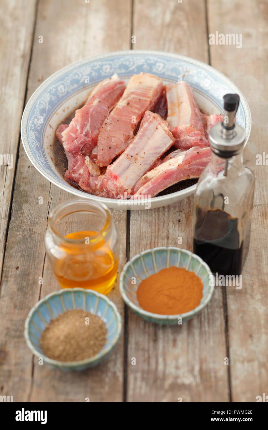 Pork ribs with ingredients for the marinade (honey, soy sauce, spices