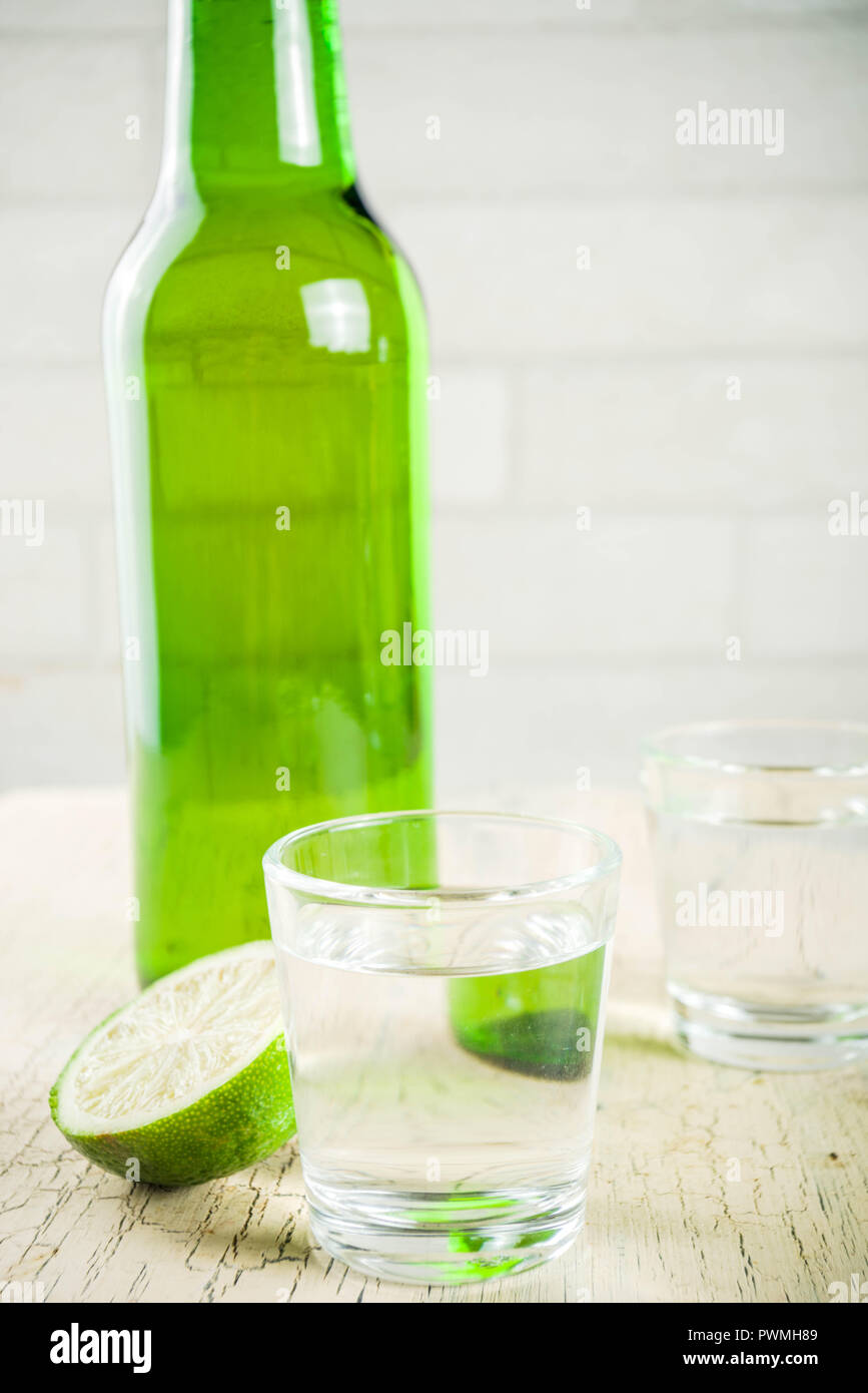 Traditional korean alcohol drink soju on light concrete background copy