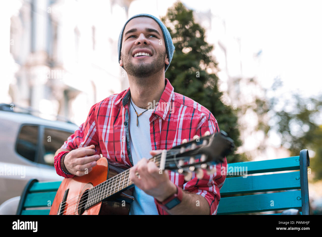Vigorous street musician improvising on his guitar Stock Photo