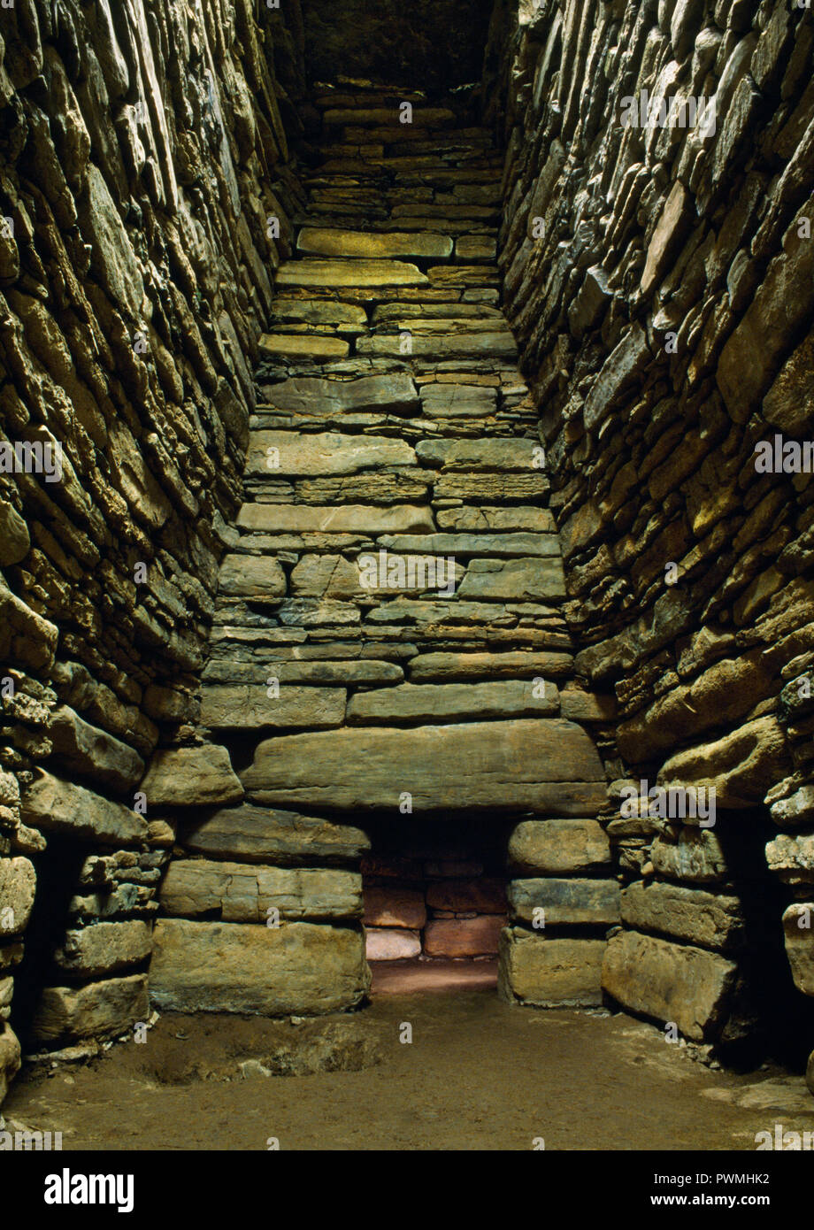 View SW of the interior of Quoyness Neolithic chambered cairn, Sanday, Orkney, UK, showing entrances to 3 of the 6 burial cells off the main chamber. Stock Photo