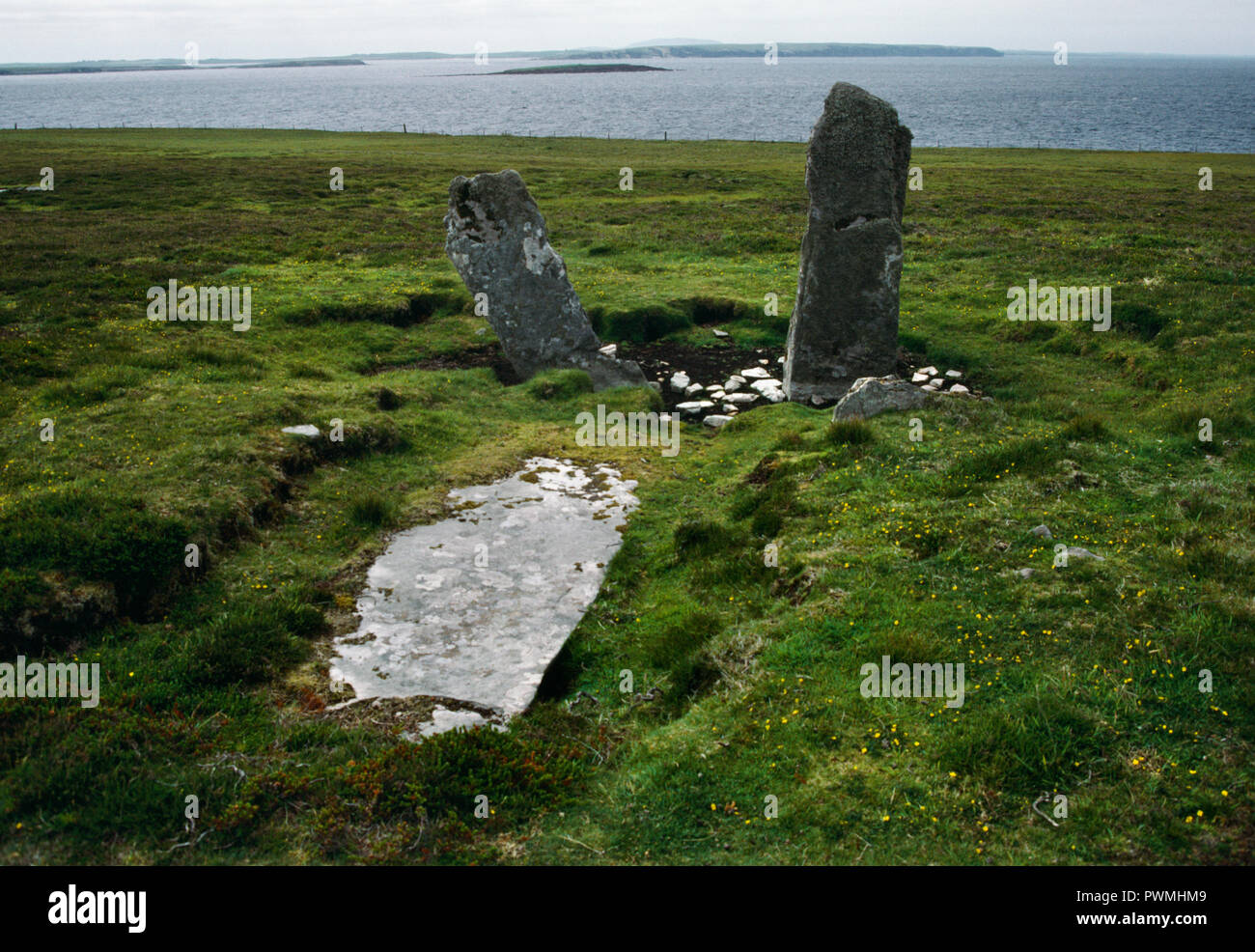 View W at the remains of a Neolithic chambered tomb (stalled cairn) on a moorland hillside overlooking the Sound of Fara on NW coast of Eday, Orkney. Stock Photo