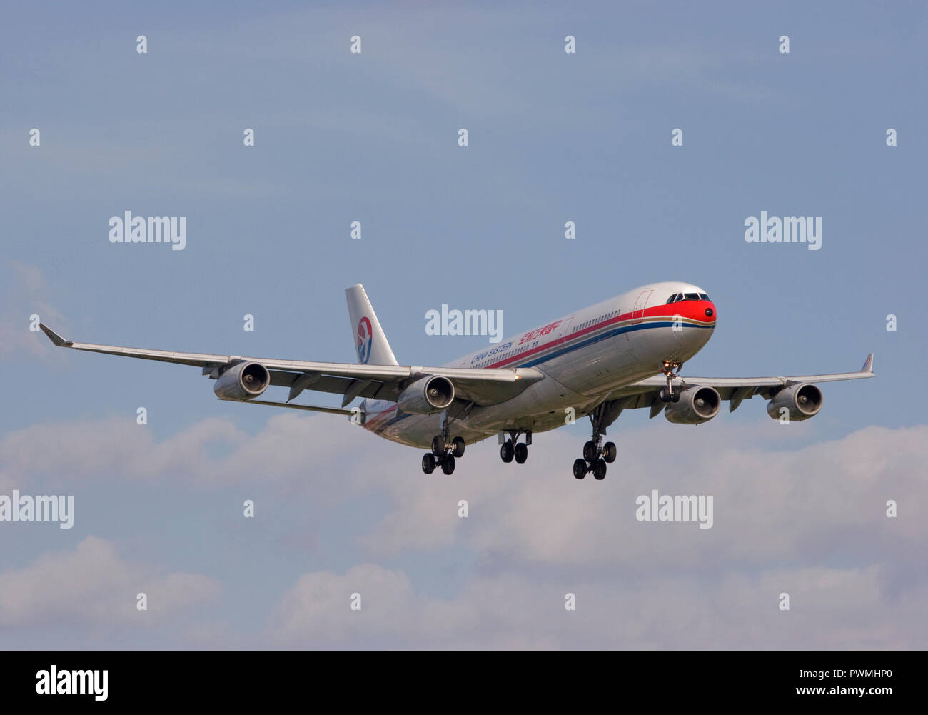 China Eastern Airlines Airbus A340-313X landing at London Heathrow airport. Stock Photo