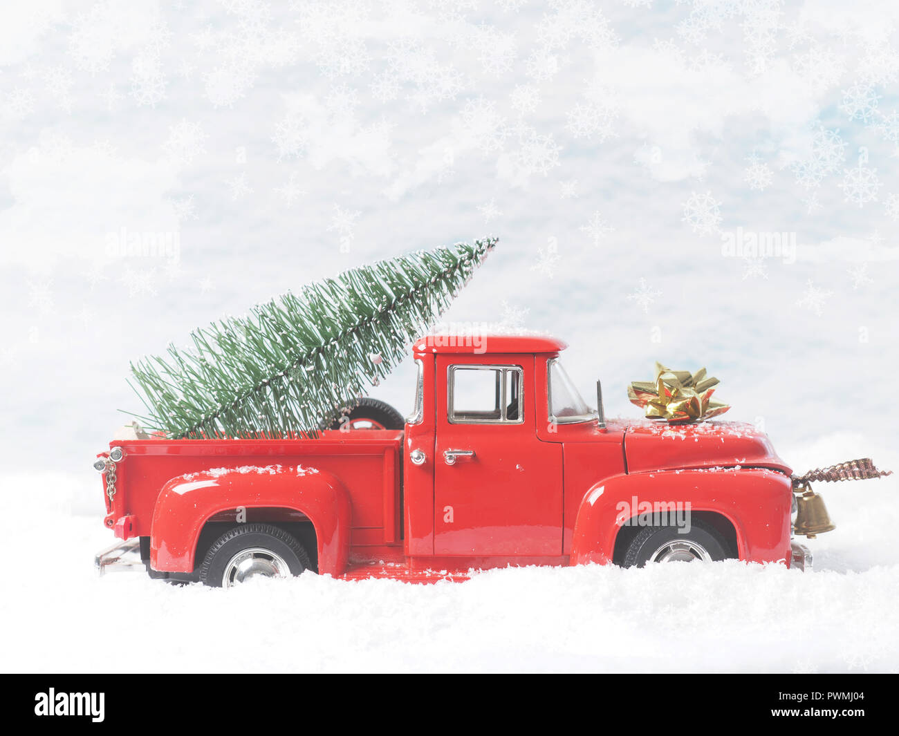 Red vintage pickup truck with a Christmas tree in winter landscape ...