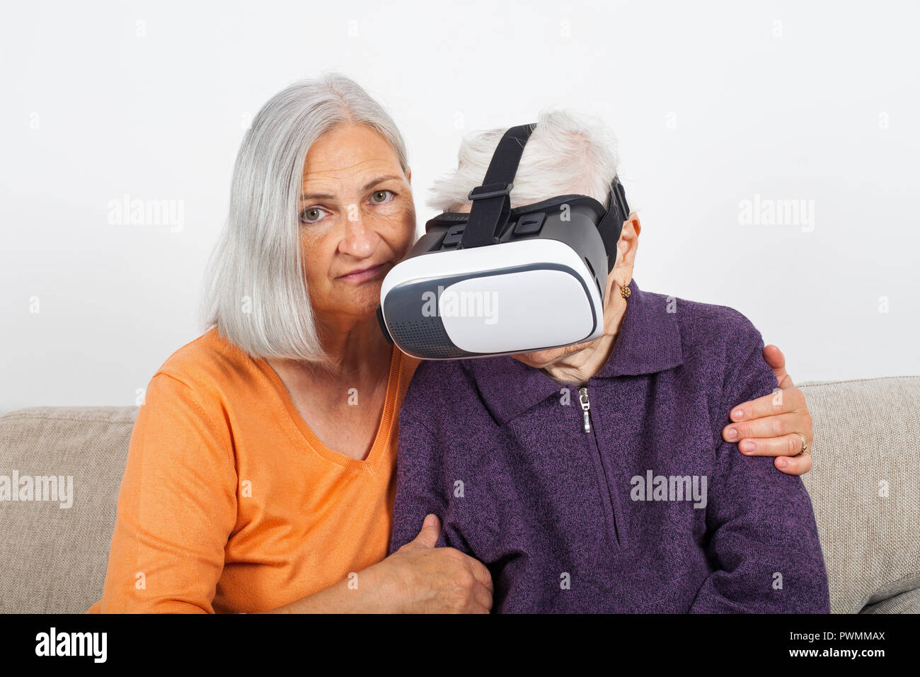 Elderly women experiencing virtual reality video with headset Stock
