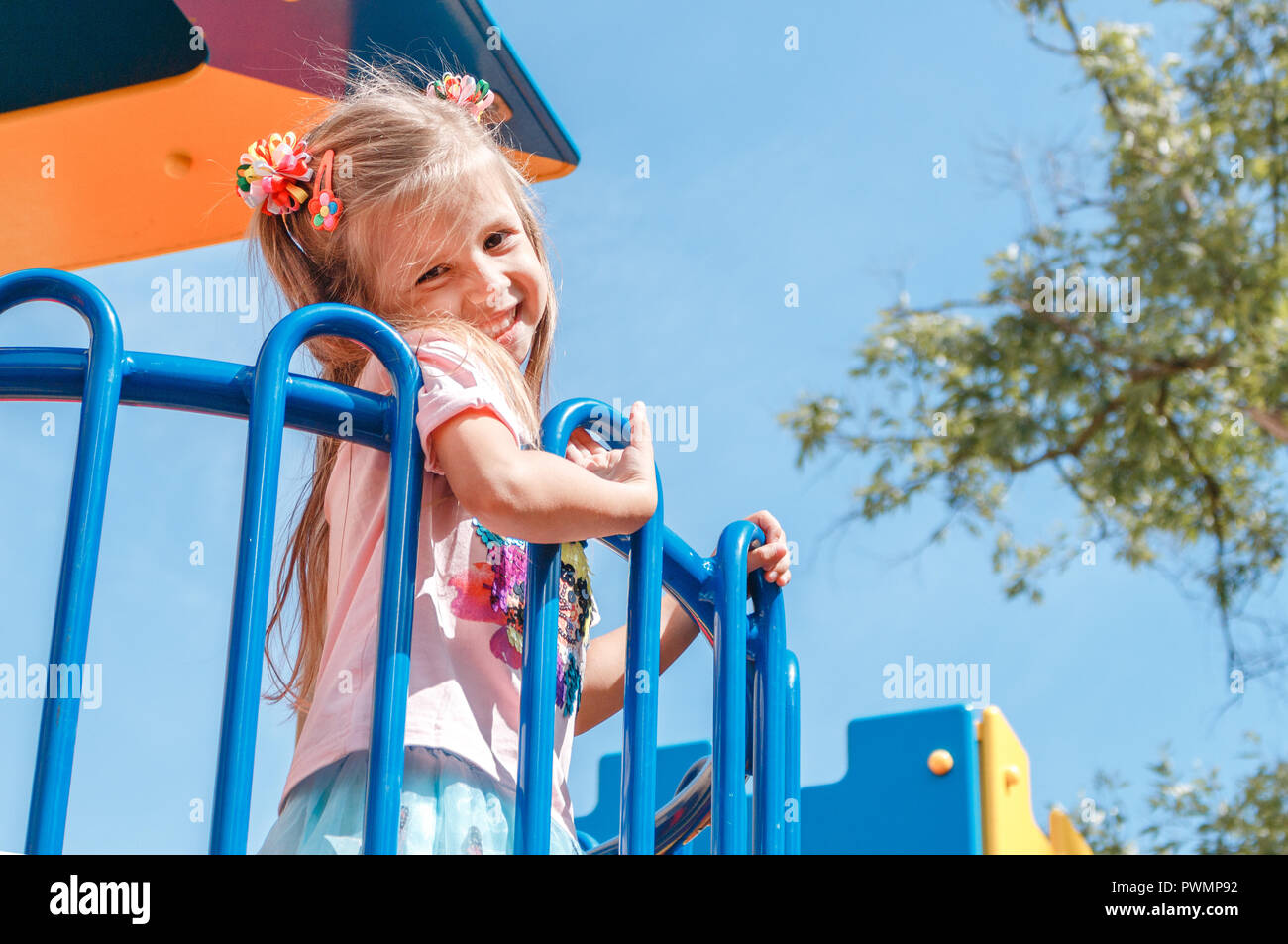 Smiling little girl at playground in the park Stock Photo - Alamy