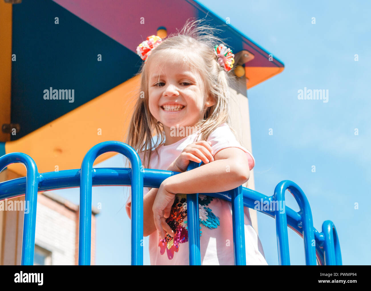 Smiling little girl at playground in the park Stock Photo - Alamy