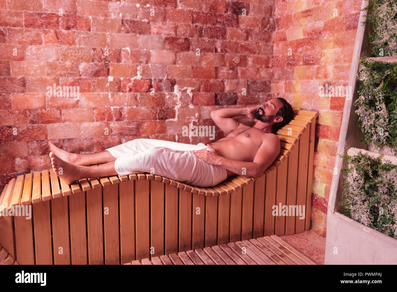 Nice brunette young man feeling absolutely relaxed Stock Photo