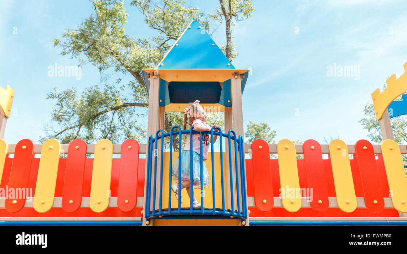 Smiling little girl at playground in the park Stock Photo - Alamy