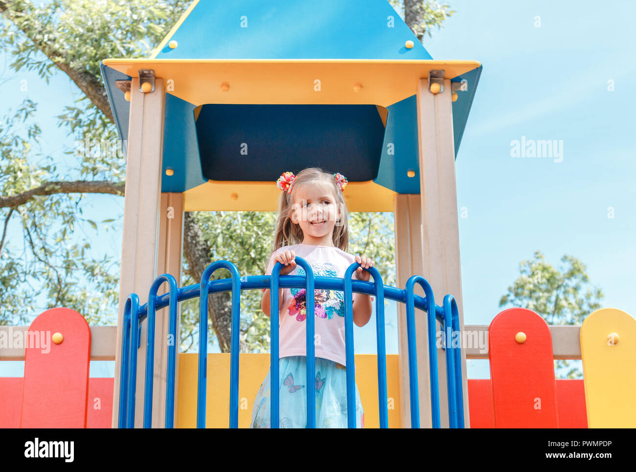 Smiling little girl at playground in the park Stock Photo - Alamy