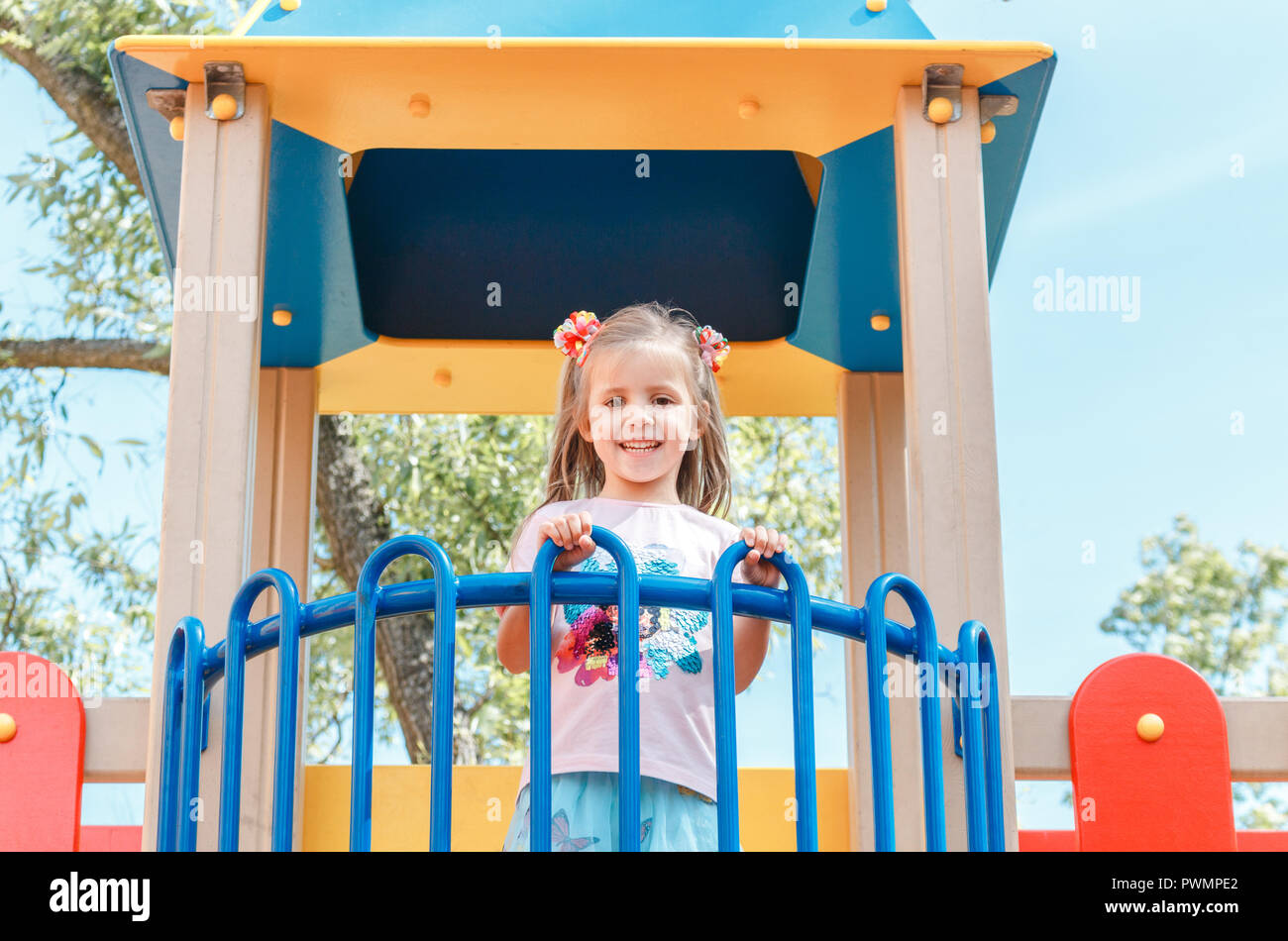Smiling little girl at playground in the park Stock Photo - Alamy