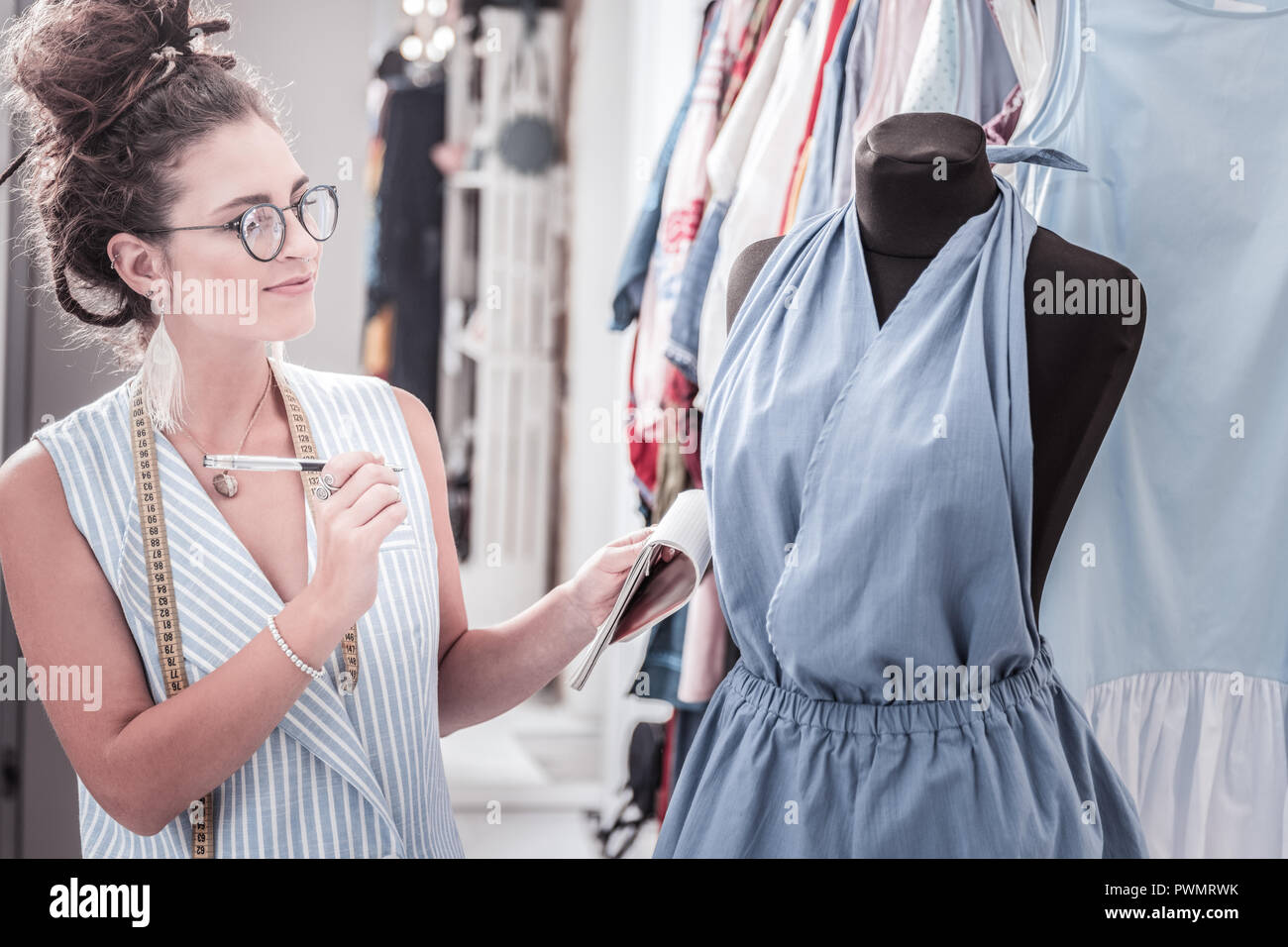 Inspired fashion assistant wearing glasses feeling serious tailoring
