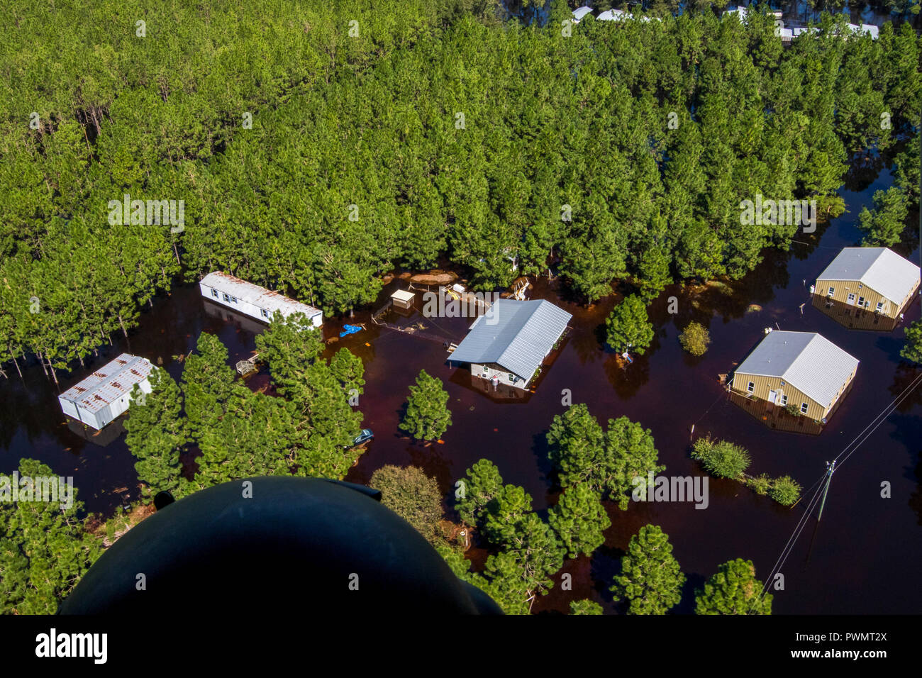 Flood waters engulf a farm and buildings along the Cape Fear River in