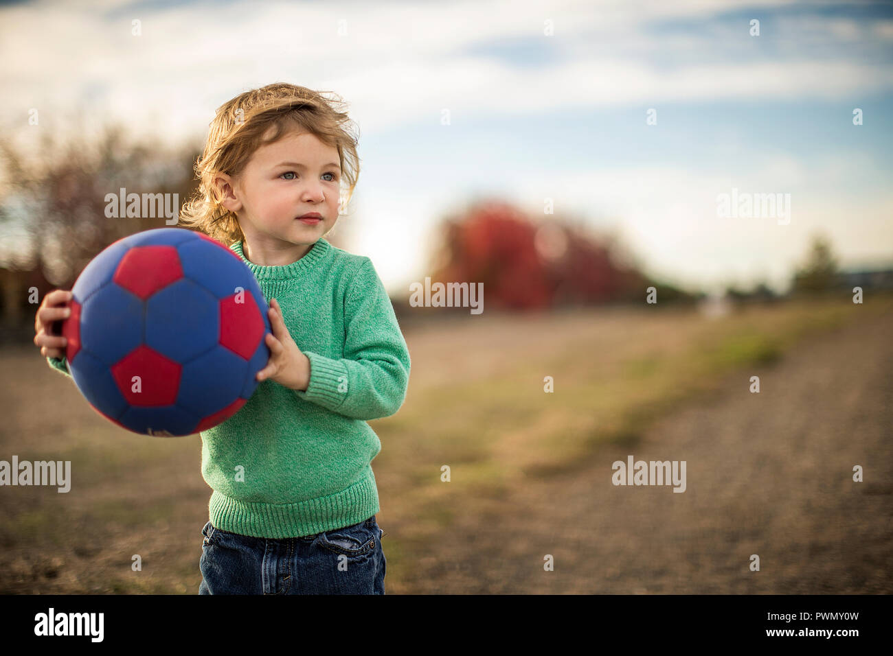 Young boy playing with ball Stock Photo - Alamy