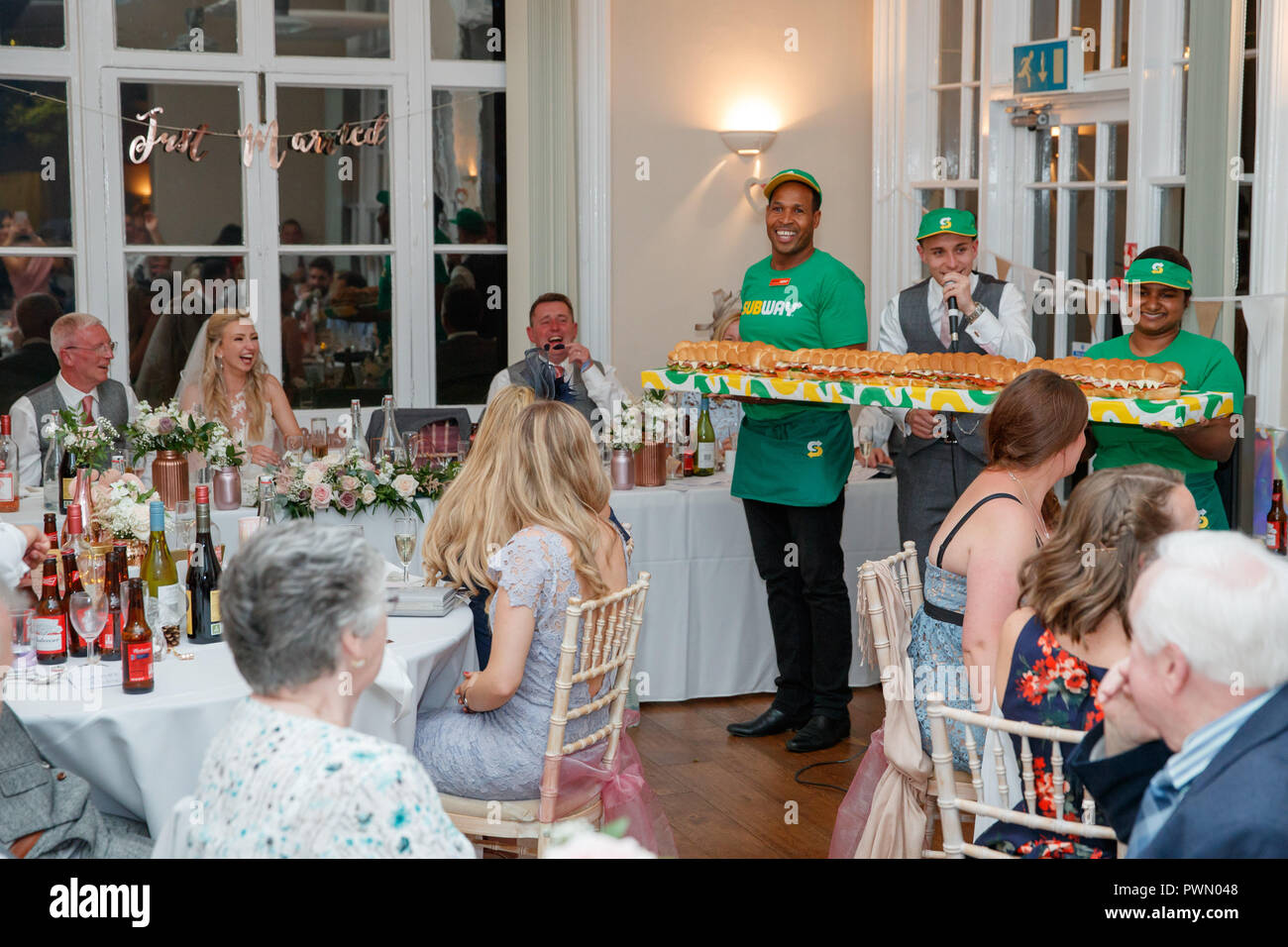 Subway Sandwich Artists Justin Pringle and Yasoda Jayaweera deliver a BMT Giant Sub to the wedding reception of James and Lucinda Coad at Abbotts Hill School in Hemel Hempstead.  Three Giant Subs, each measuring six-foot in length and designed to feed up to 25 people, were created for the reception on Saturday 15 September.  Featuring: Justin Pringle, Yasoda Jayaweera Where: Hemel Hempstead, Hertfordshire, United Kingdom When: 15 Sep 2018 Credit: Ben Queenborough/PinPep/WENN.com Stock Photo