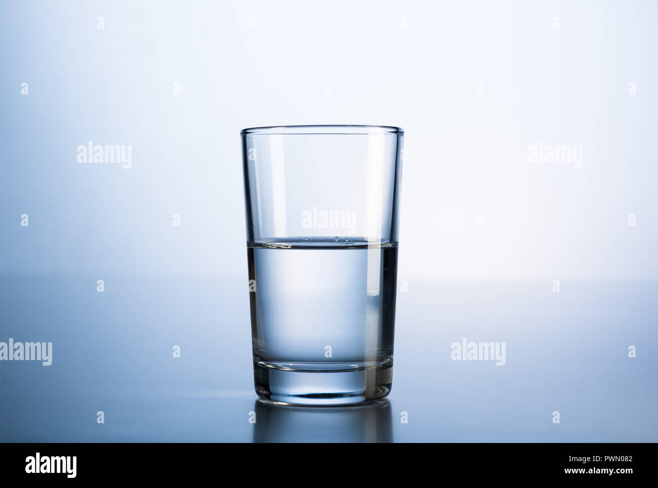 A glass of mineral water in fresh blue light Stock Photo - Alamy