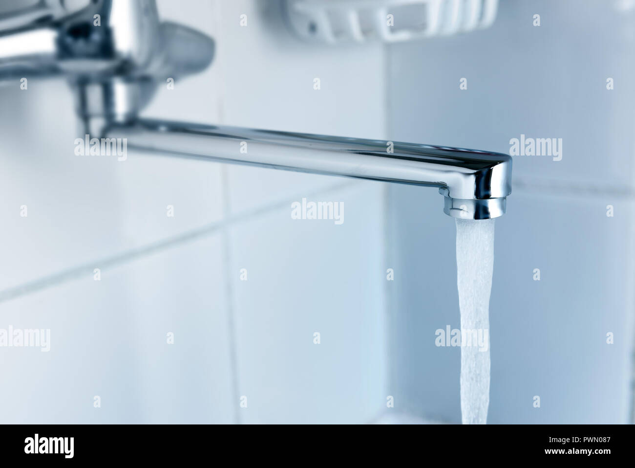 Water runs out of a tap in kitchen Stock Photo Alamy