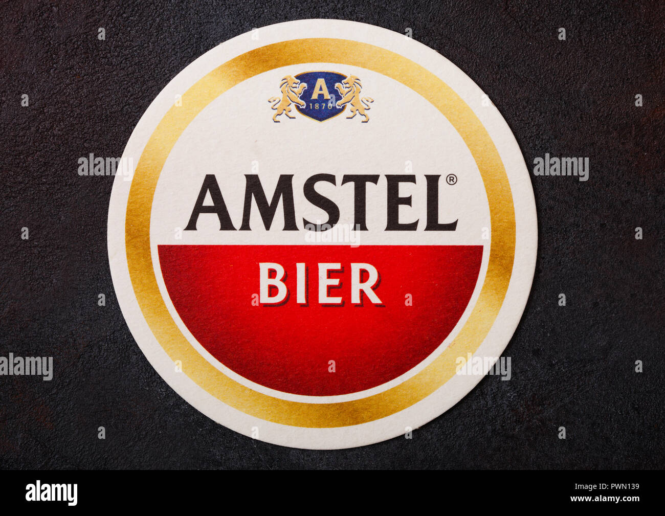 LONDON, UK - AUGUST 22, 2018: Amstel Lager paper beer beermat coaster on black background. Stock Photo