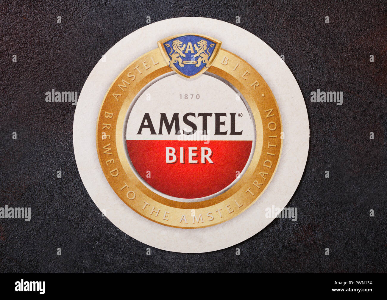 LONDON, UK - AUGUST 22, 2018: Amstel Lager paper beer beermat coaster on black background. Stock Photo