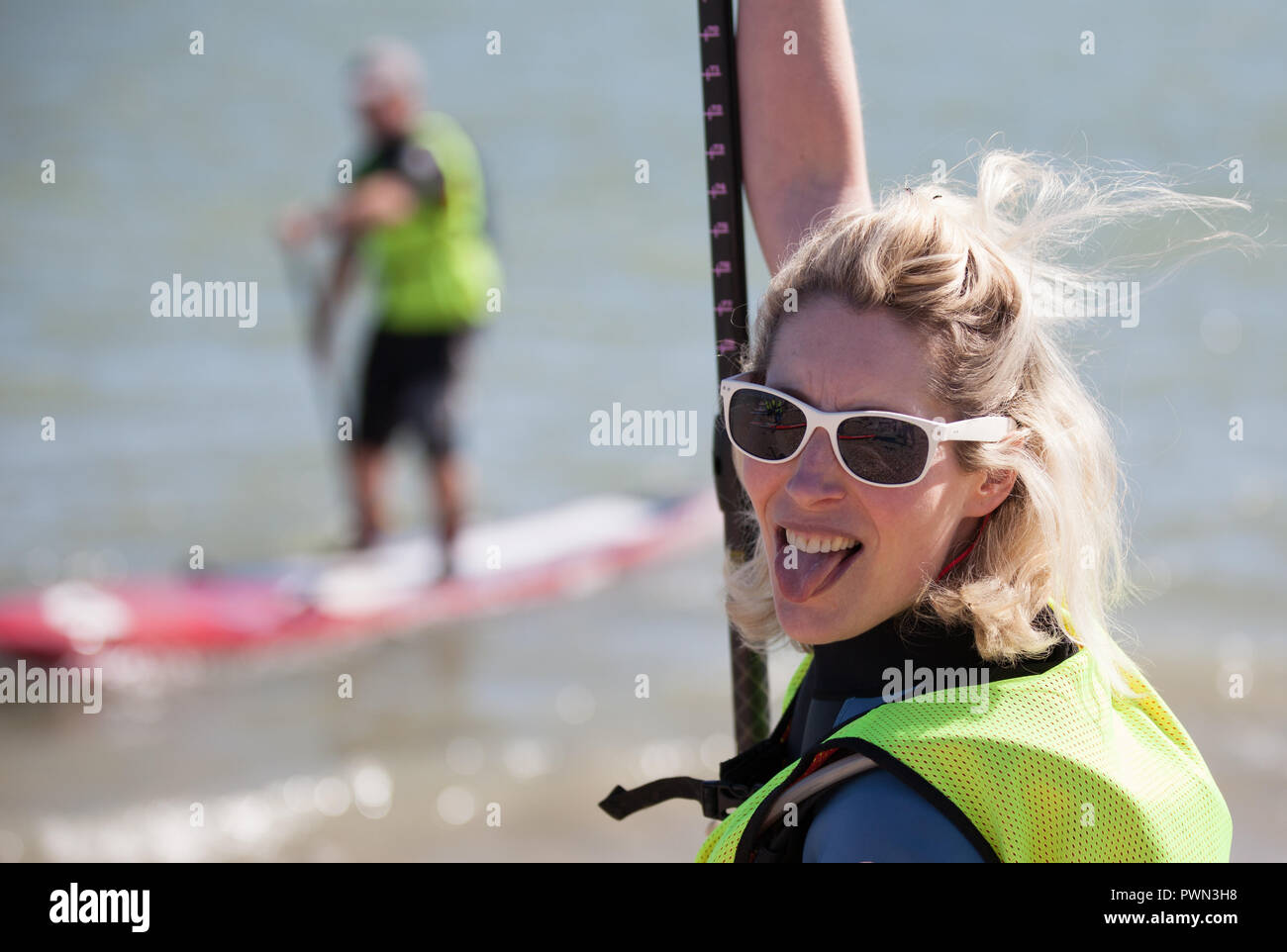 woman about to go paddle boarding on the beach Stock Photo Alamy