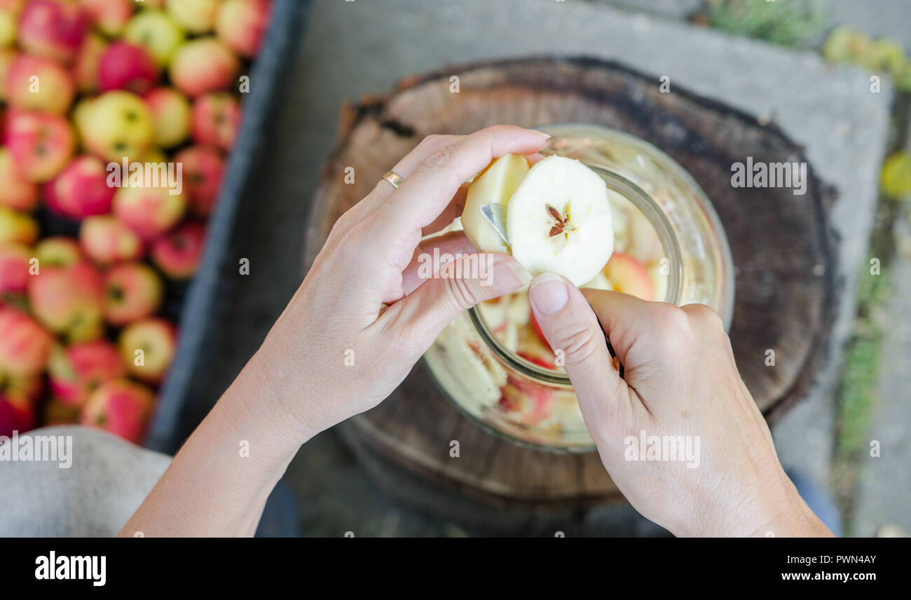 Making of apple vinegar - scene from above - hand peeling apples Stock Photo